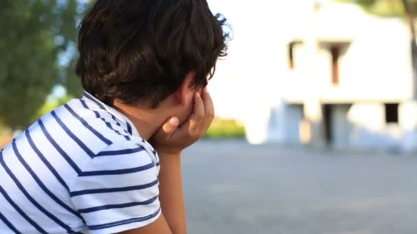 Закрыть одинокого симпатичного ребенка, оглядывающегося вокруг — стоковое видео