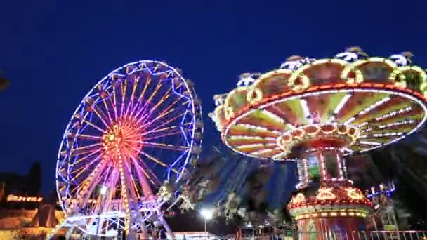 Swing and Ferris Wheel at amusement park time lapse — Stock Video