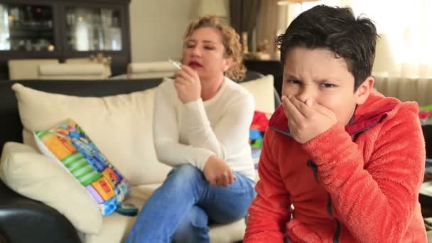 Roken van de moeder in de buurt van haar hoesten kind — Stockvideo