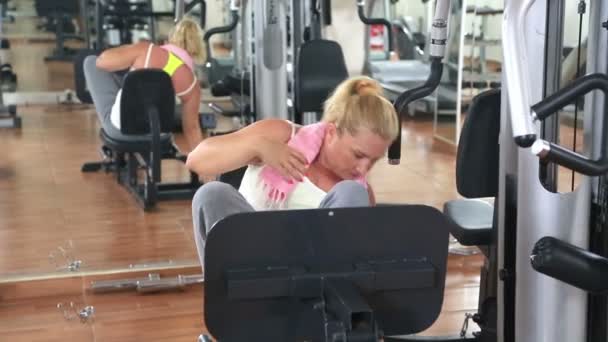 Mujer haciendo ejercicio en la máquina de fitness — Vídeos de Stock