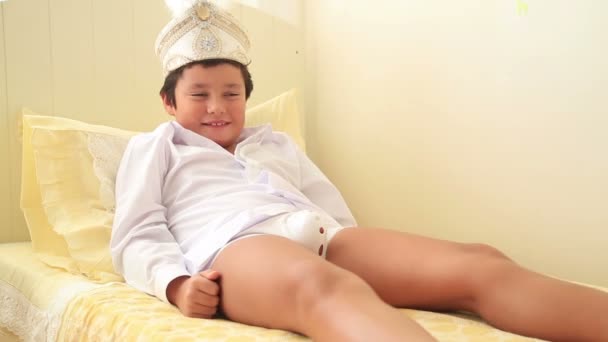 Portrait of a  happy child after circumcision operation — Stock Video