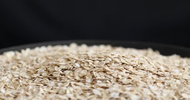 Pile Uncooked Rolled Oats Rotating Black Background — Stock Video