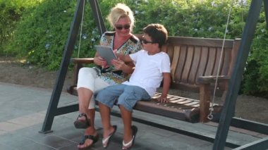 Anne ve oğlu sallanan ve dijital tablet 2 kullanma