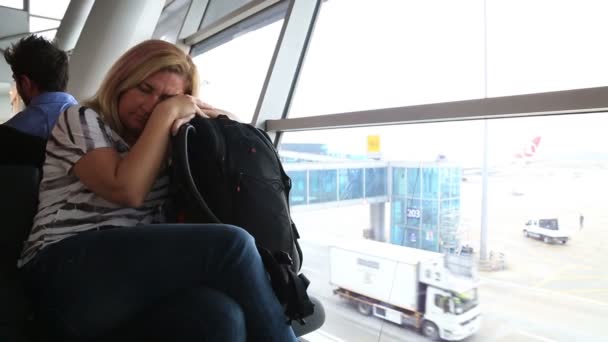 Tired woman waiting at the airport — Stock Video