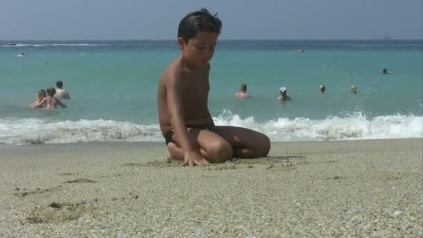 Παιδί παίζει με άμμο στην παραλία — Αρχείο Βίντεο