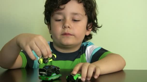 Boy plays with his  toy cars — Stock Video