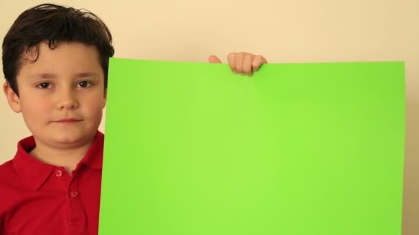 Child Holding Onto A Green Screen — Stock Video