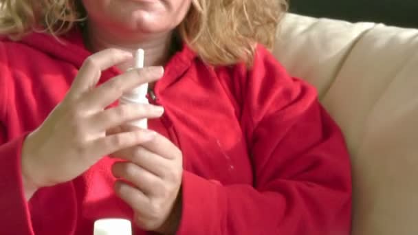 Sick women using a nasal spray — Stock Video