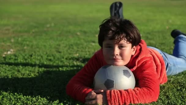 Bir kameraya gülümseyen bir top ile mutlu bir çocuk portresi — Stok video