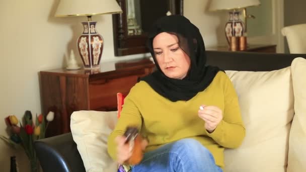Muslim woman taking pill — Stock Video