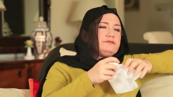 Tired, sick muslim woman sneezing — Stock Video