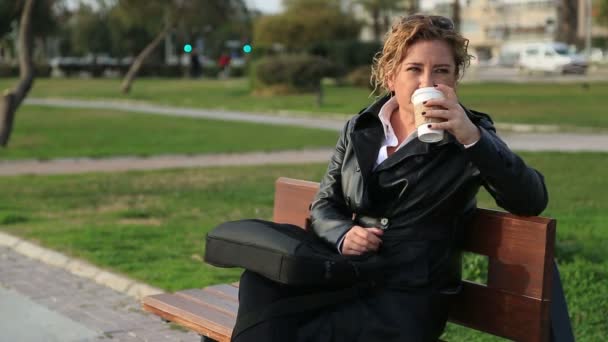Деловая женщина на перерыве пьет кофе в парке — стоковое видео