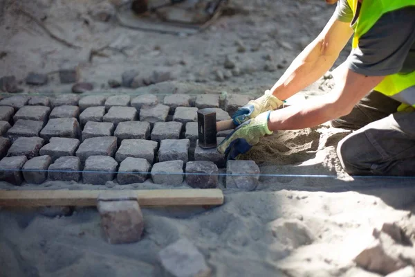Road repairs, installation of a new sidewalk made of ancient cobblestones