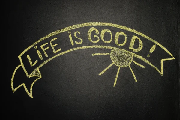 Life is good with Ribbon Banner, written with chalk on a blackbo