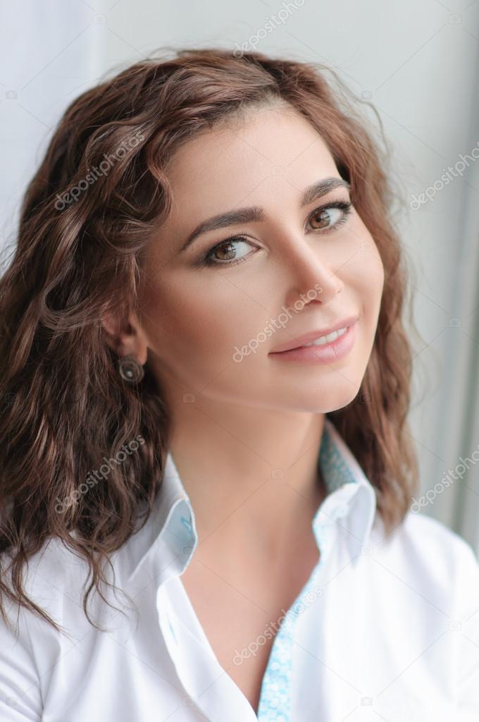 Beauty model woman portrait with curly brown-haired