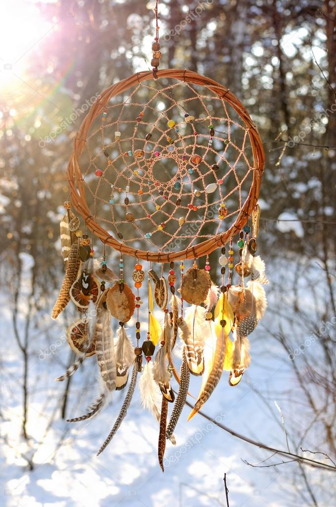 Handmade colorfull dream catcher in the snowy forest