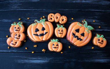 Cadılar bayramı meyveleri ve dikenleri için zencefilli kurabiye siyah bir masada çocuklara ikram edilir.