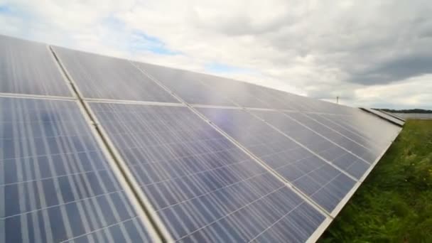 Solar panels used to generate electricity from sunlight against clouds and sky. — Stock Video