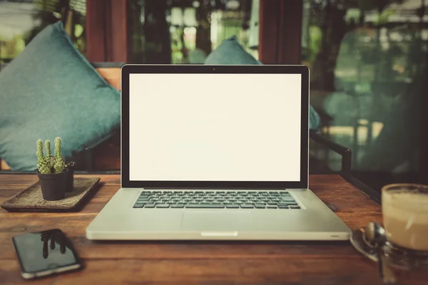 Laptop with coffee cup home office