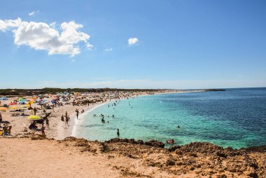 the beach with peaple and blu sea on the island of Sardinia.North Sardinia