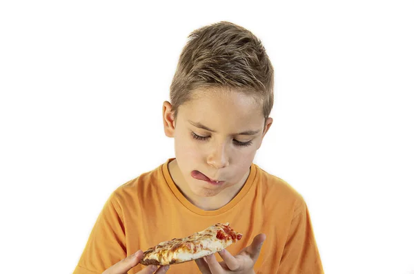 The boy eats delicious pizza on a white background — Stock Photo, Image