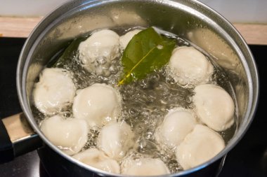 Cooking russian pelmeni. A pot of boiled pelmeni, approx. Boiled water