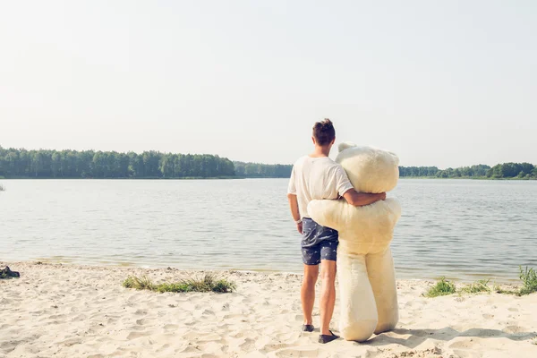 Guy with a big teddy bear — Stock Photo, Image