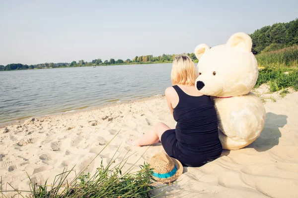 Beautiful woman with a teddy bear — Stock Photo, Image