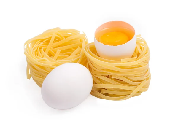 Eggs and paste tagliatelleon isolated on the white — Stock Photo, Image