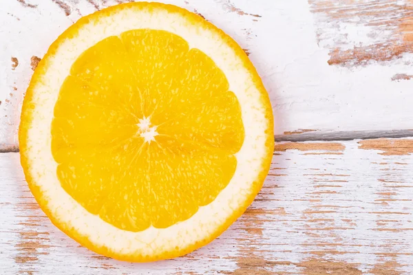 Orange segment on a  wooden table — Stock Photo, Image