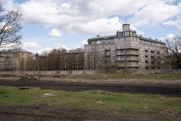 view of a large building from the backyard, with a beautiful sky