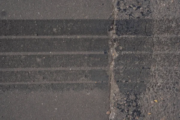 asphalt close-up with tire trace