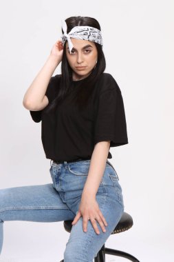 Siyah saçlı, gözlüklü, beyaz tenli güzel bir kız stüdyoda poz veriyor. Tarz, trendler, moda konsepti.
