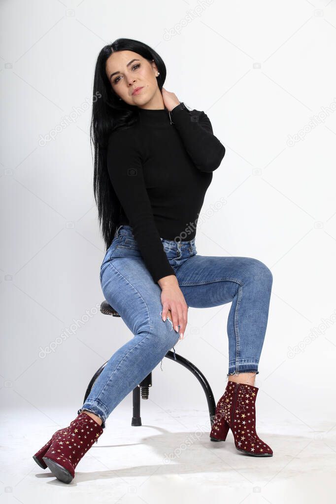 Attractive european girl with black hair and glasses posing in studio on isolated background. Style, trends, fashion concept.