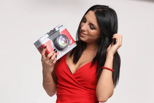 Beautiful, fancy glamourous caucasian girl with black hair posing in studio. Style, trends, lifestyle, glamour. Fashion concept.