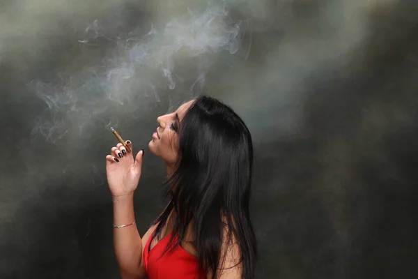 Beautiful, fancy glamourous caucasian girl with black hair posing in studio. Style, trends, lifestyle, glamour. Fashion concept.