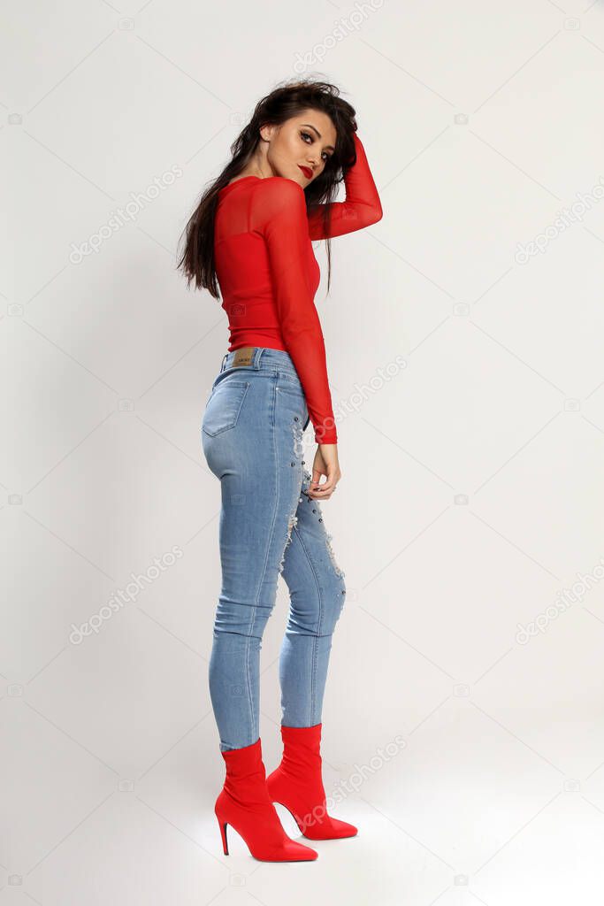 Beautiful brunette caucasian girl with long hair posing in studio on isolated background. Style, fashion trends concept.