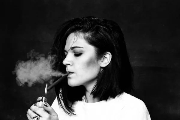 stock image Beautiful european bossy brunette girl smoking a cigarillo like a boss in studio on isolated background. Modeling, style, fashion concept. Noir effect