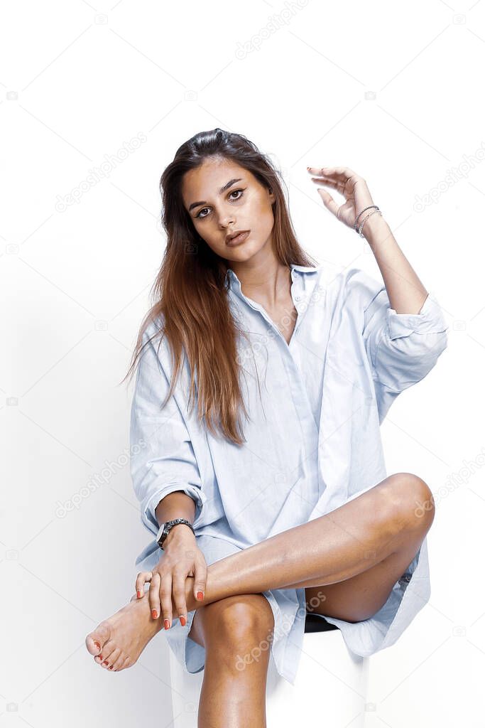 Beautiful brunette female model posing in studio on isolated background. Style, trends, fashion concept.