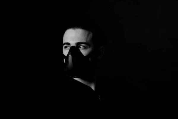 Young male model with mask posing in studio. Fantasy, Halloween, Sci-Fi concept.