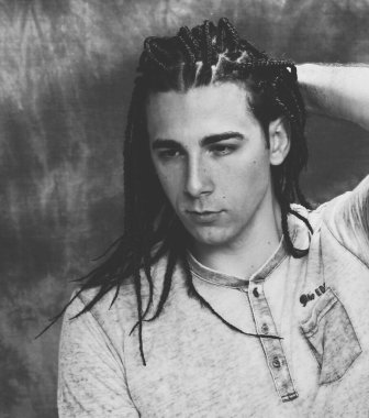 İzole edilmiş arka planda afro örgülü şık erkek model. Tarz, trendler, moda konsepti.