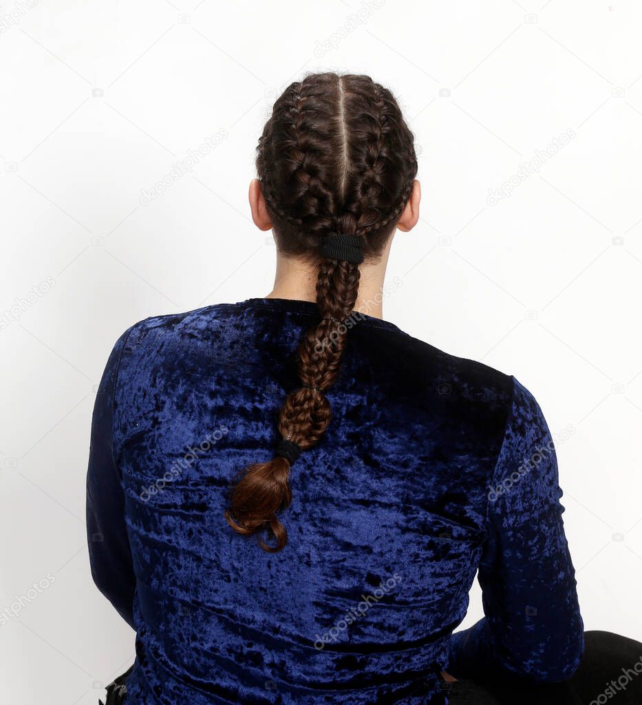 Attractive male model with braids posing in studio. Avantgarde, style, fashion concept.