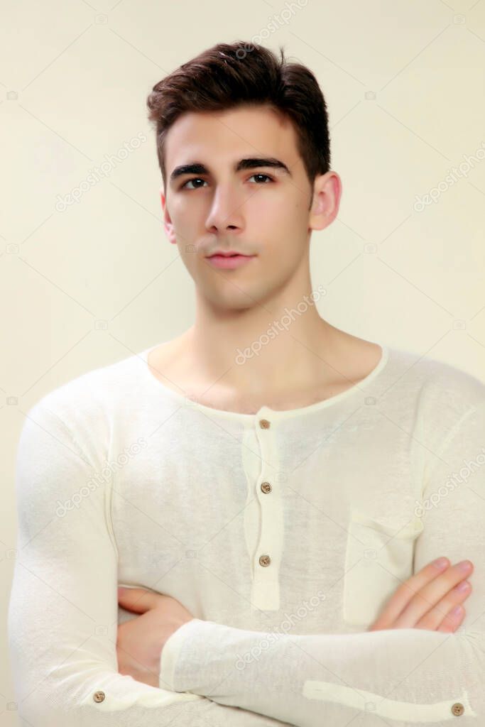 Attractive male model with short hair posing in studio on isolated background. Style, trends, fashion concept.