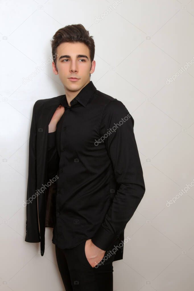 Attractive male model with short hair posing in studio on isolated background. Style, trends, fashion concept.