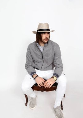 Uzun saçlı ve sakallı çekici erkek model izole bir arka planda stüdyoda poz veriyor. Tarz, trendler, moda konsepti.