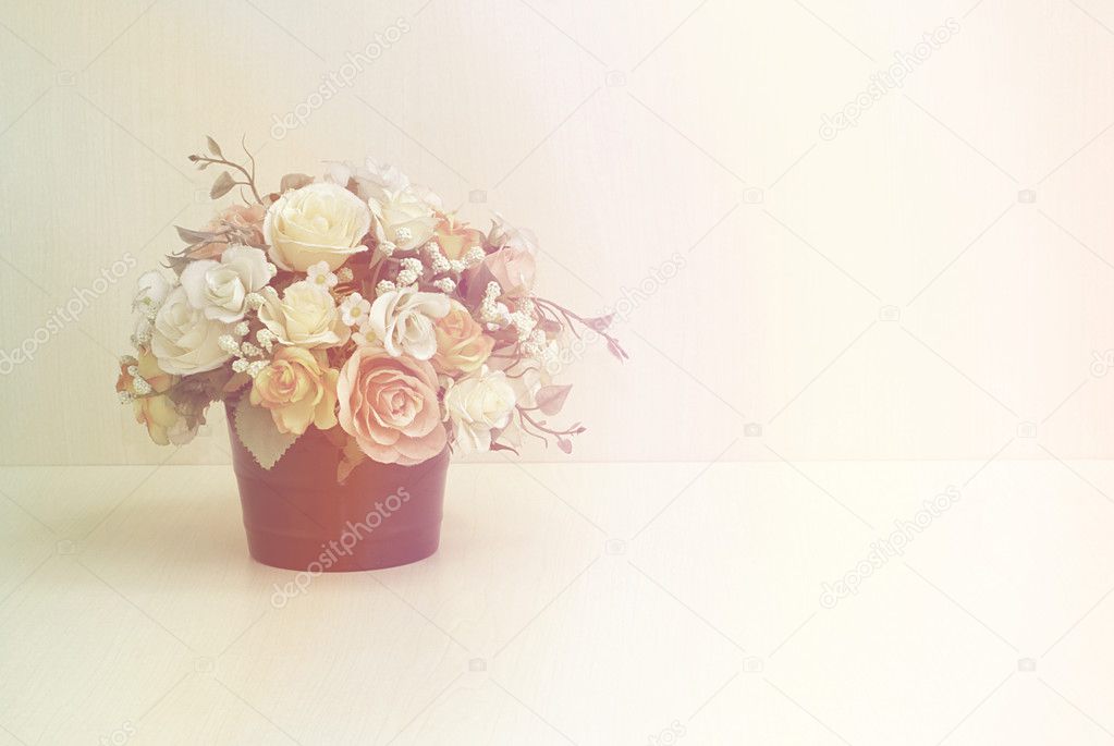 Artificial flowers on wood table