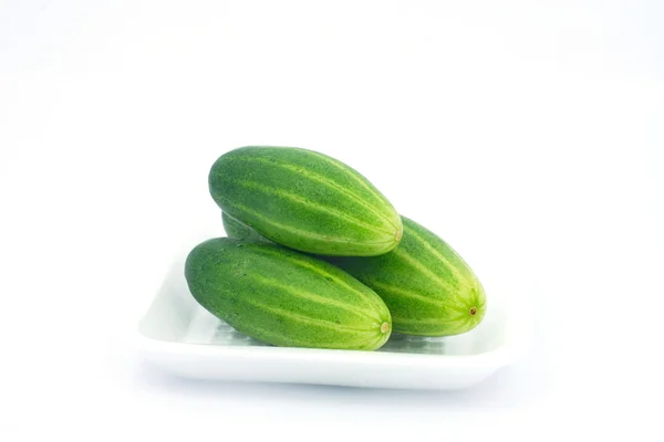 green cucumber in foam sheet on isolate white background