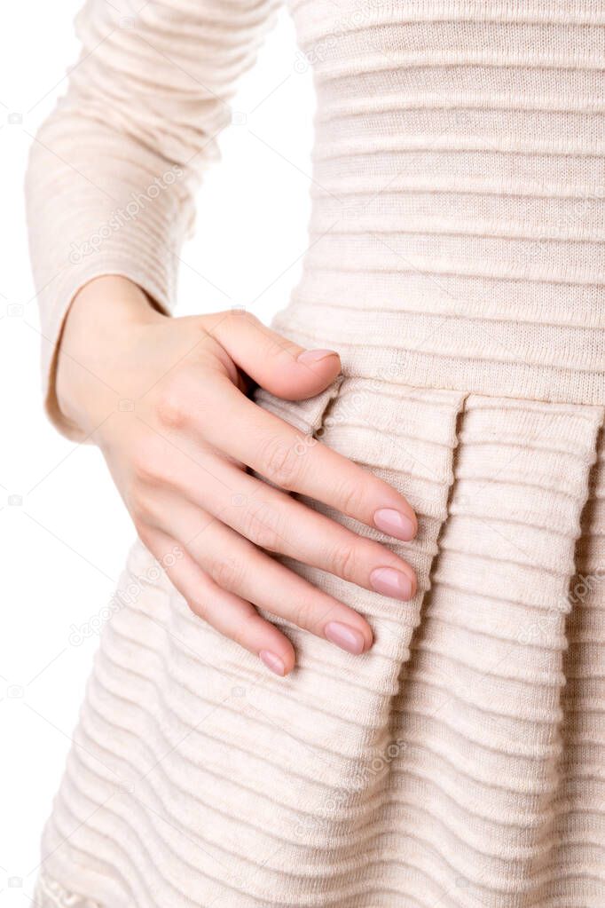 Woman with groomed hands with nude beige pink nail design in dress