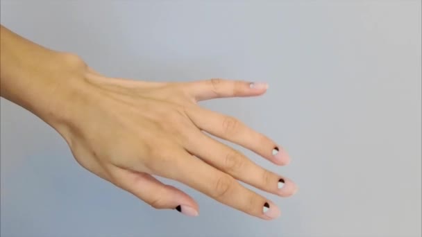 Kvinna hand med trendig naken spik design på grå bakgrund — Stockvideo