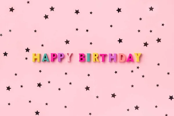 Happy birthday inscription from wooden colorful letters with confetti — Stock Photo, Image